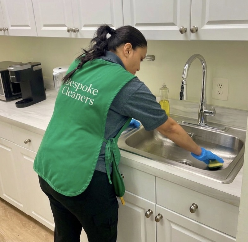 Bespoke Cleaners team member cleaning office kitchen sink