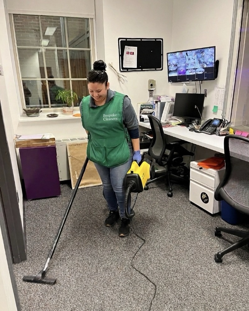 Bespoke Cleaners team member vacuuming office carpet in NYC